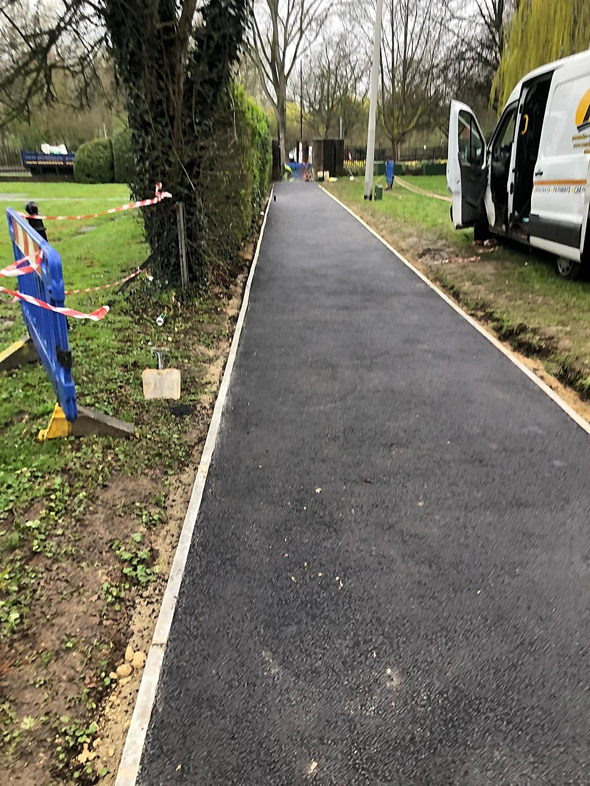 A liveried Meads Resurfacing van on site beside a freshly laid tarmac pathway